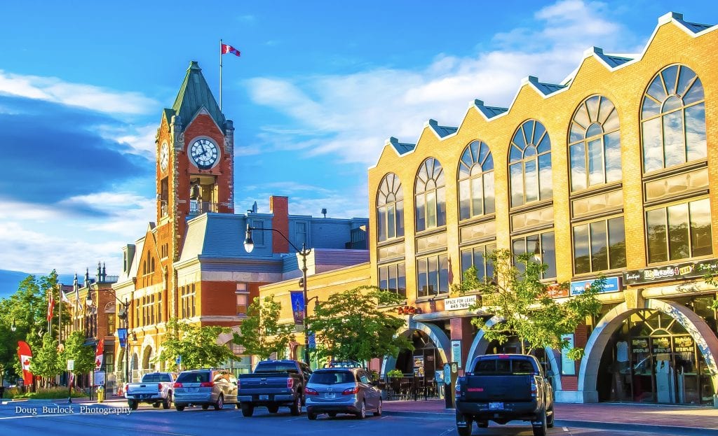 Cars parked on a street with historic brick buildings show why Collingwood is so charming.